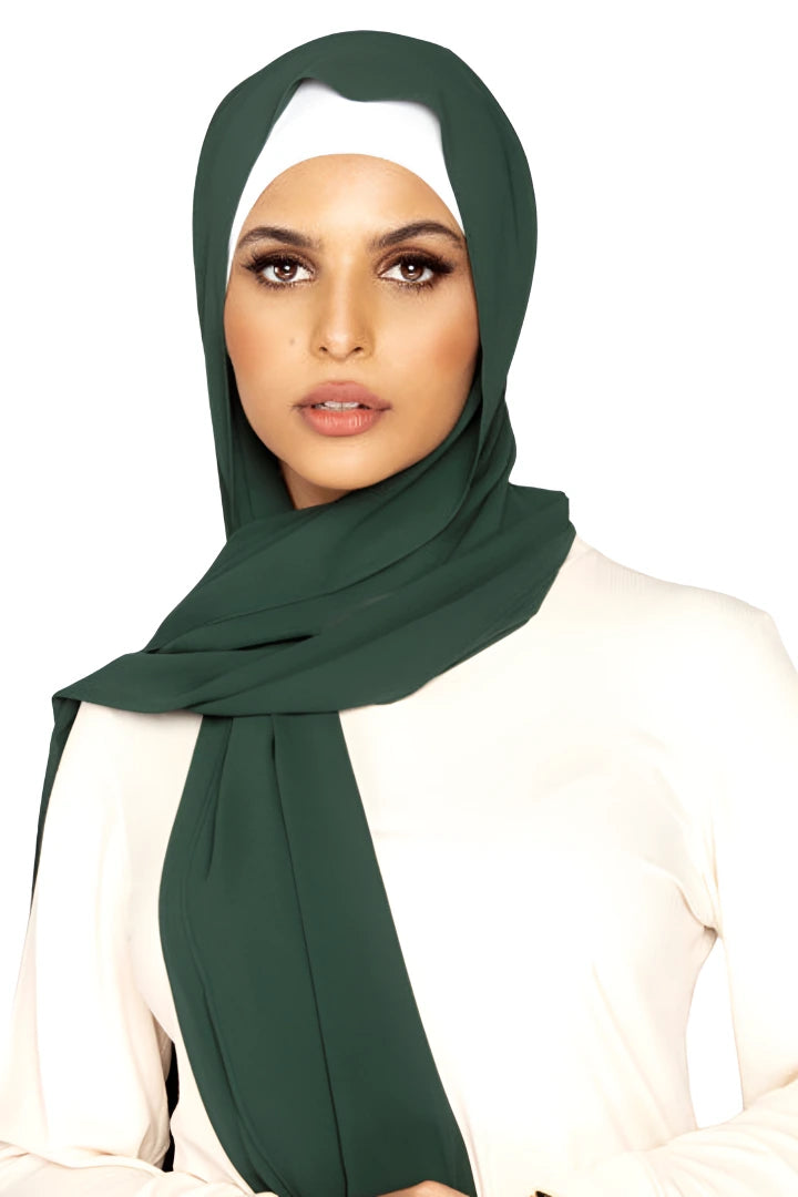Woman wearing a green hijab on a white background
