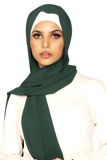 Woman wearing a green hijab on a white background