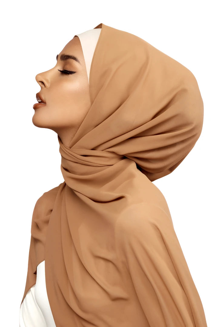 Woman wearing a brown hijab on a white background