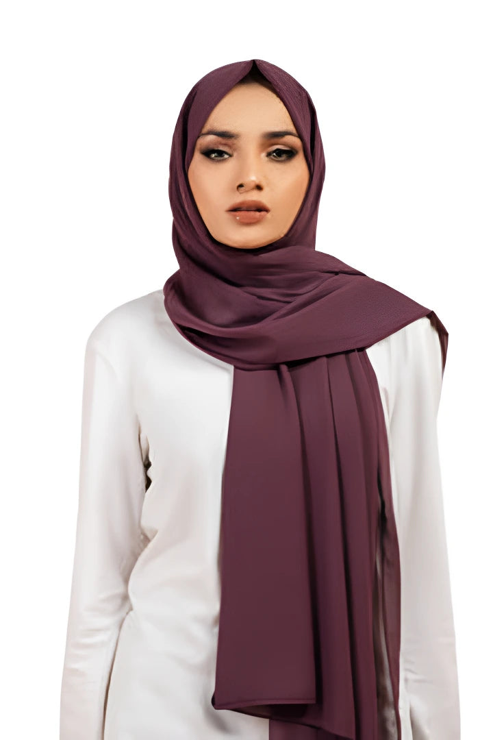 Woman wearing a dark purple hijab on a white background