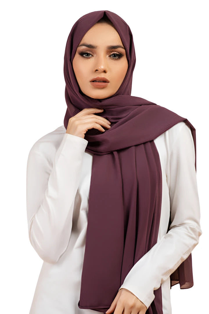 Woman wearing a dark purple hijab on a white background
