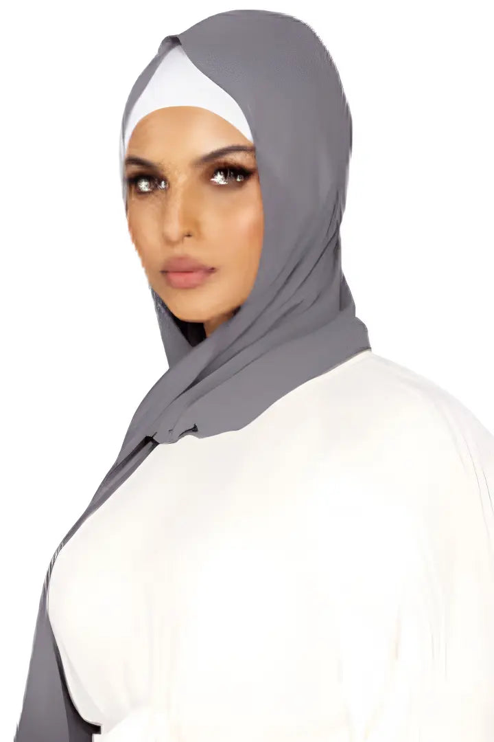 Woman wearing a gray hijab on a white background