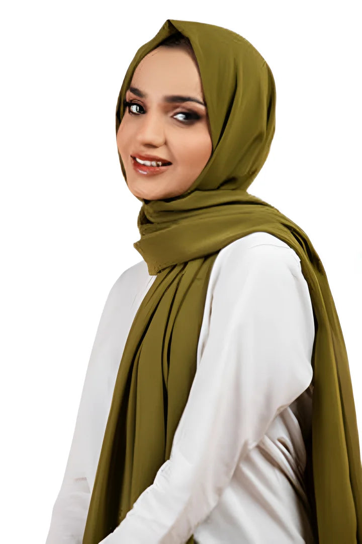 Woman wearing a green hijab on a white background