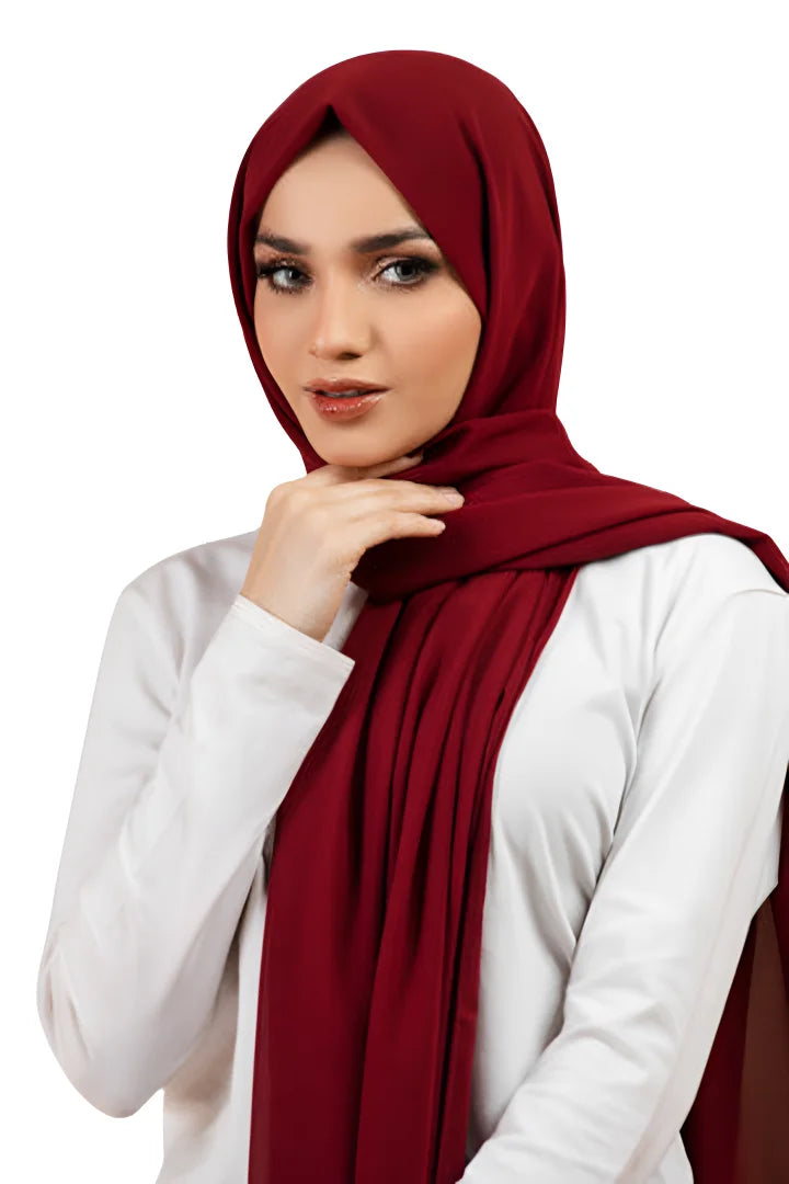 Woman wearing a red hijab and white shirt on a white background