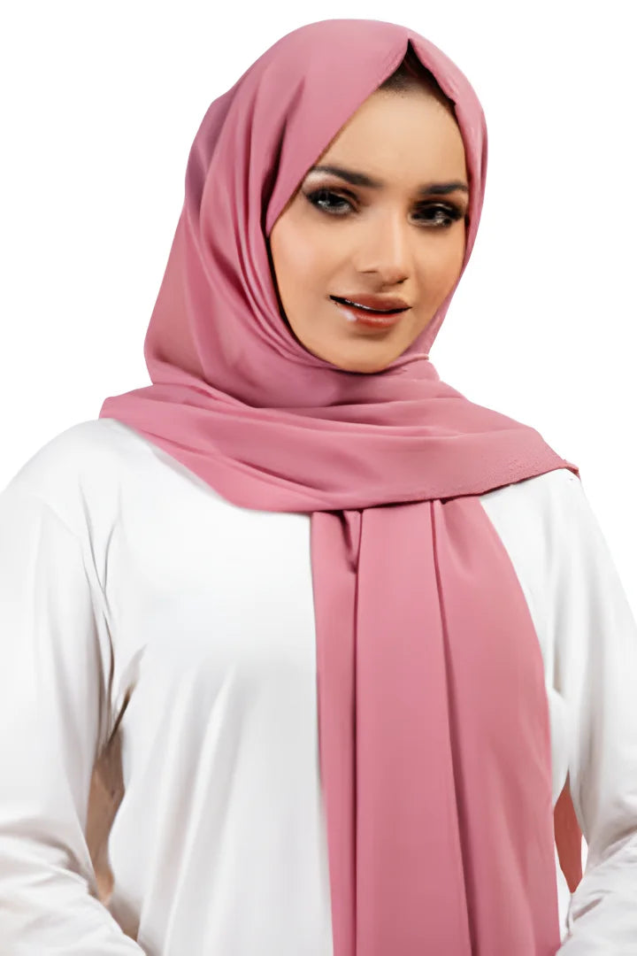 Woman wearing a pink hijab and white top on a white background