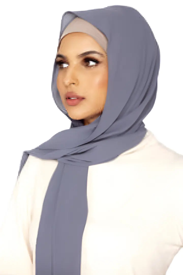 Woman wearing a gray hijab on a white background