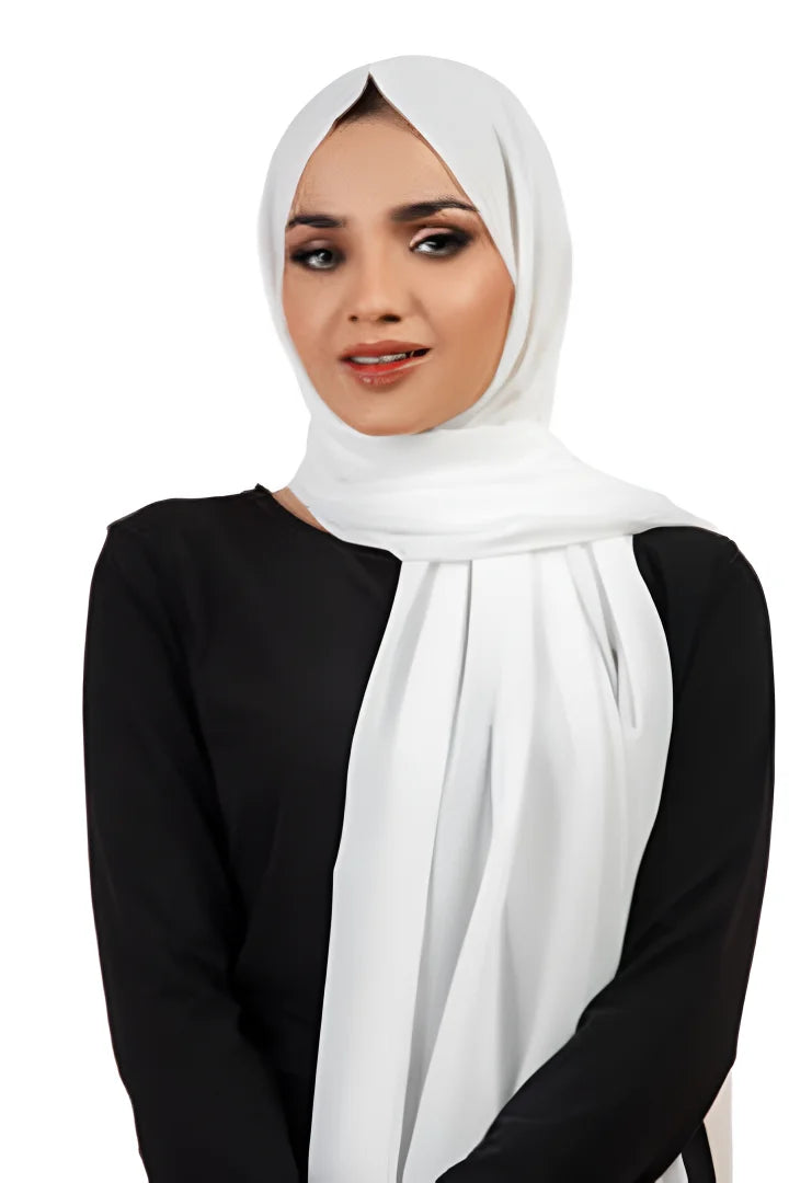 Woman wearing a white hijab and black top on a white background