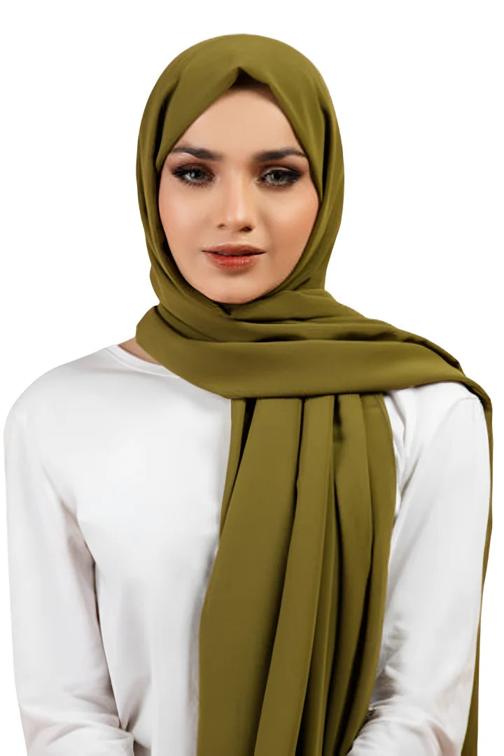 Woman wearing a green hijab on a white background