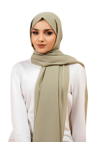 Woman wearing a beige hijab and white top on a white background