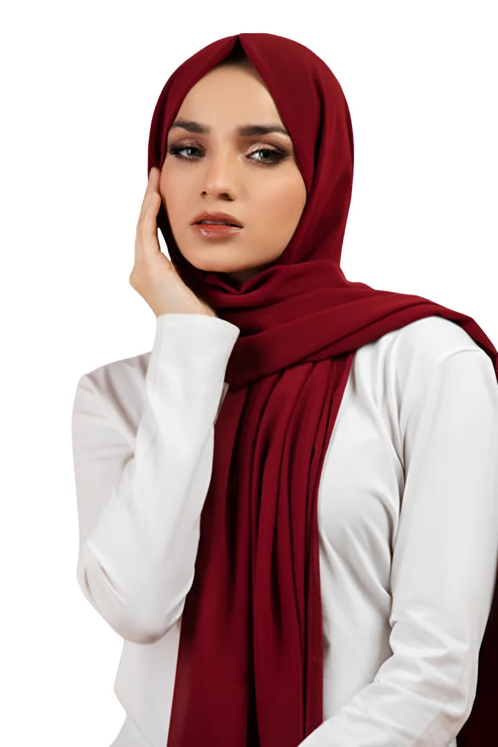 Woman wearing a red hijab and white shirt on a white background
