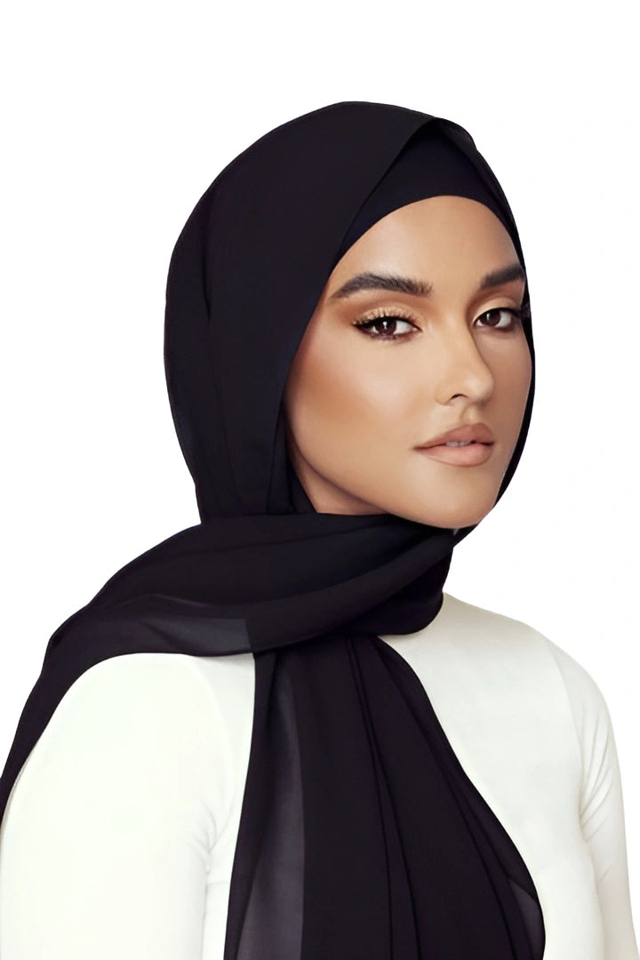 Woman wearing a black hijab on a white background