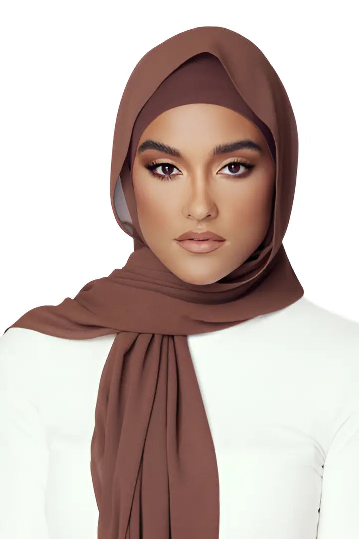 Woman wearing a brown hijab on a white background