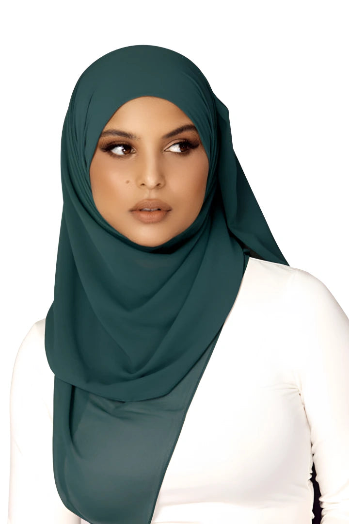 Woman wearing a dark green hijab on a white background