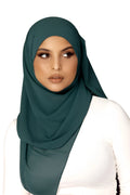 Woman wearing a dark green hijab on a white background