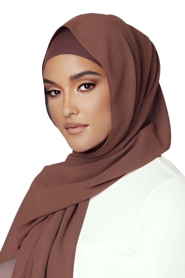 Woman wearing a brown hijab on a white background