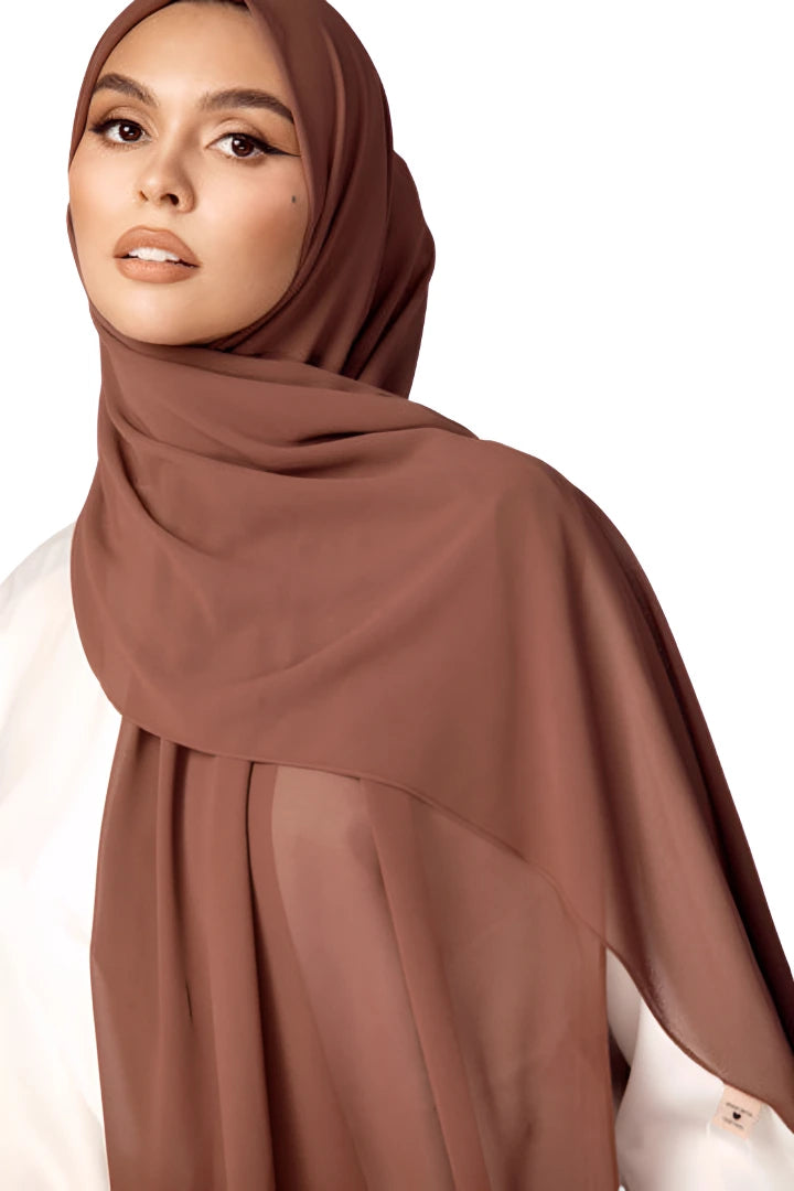 Woman wearing a brown hijab on a white background